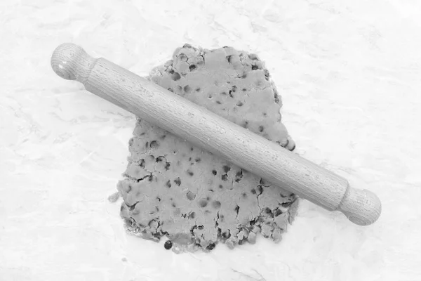 Cookie dough being rolled out with a wooden rolling pin — Stock Photo, Image