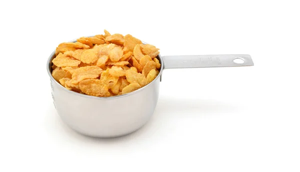 Copos de maíz cereal de desayuno en una taza de medir — Foto de Stock