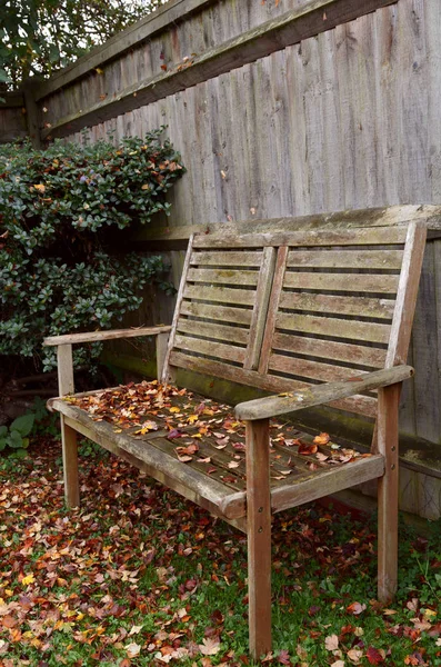 秋叶覆盖的质朴的木制长凳 — 图库照片
