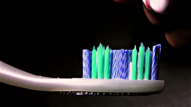 Toothpaste Squeezing Toothbrush Black Background — Stock Video