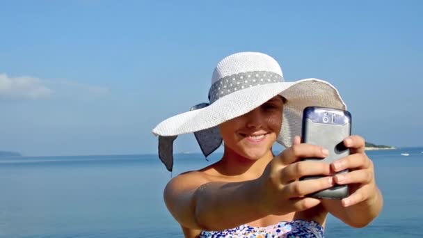 オーシャンビーチにスマート フォンで Selfie を取る若い女性 — ストック動画