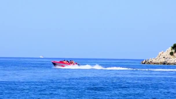 背景に灯台と島の海の表面でセーリング モーター ボート — ストック動画