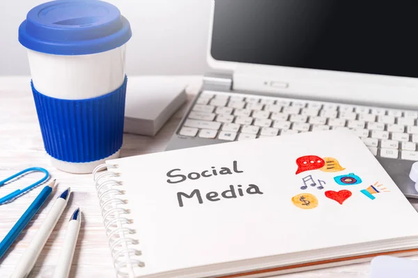 Coffee cup on working desk, Social Media concept