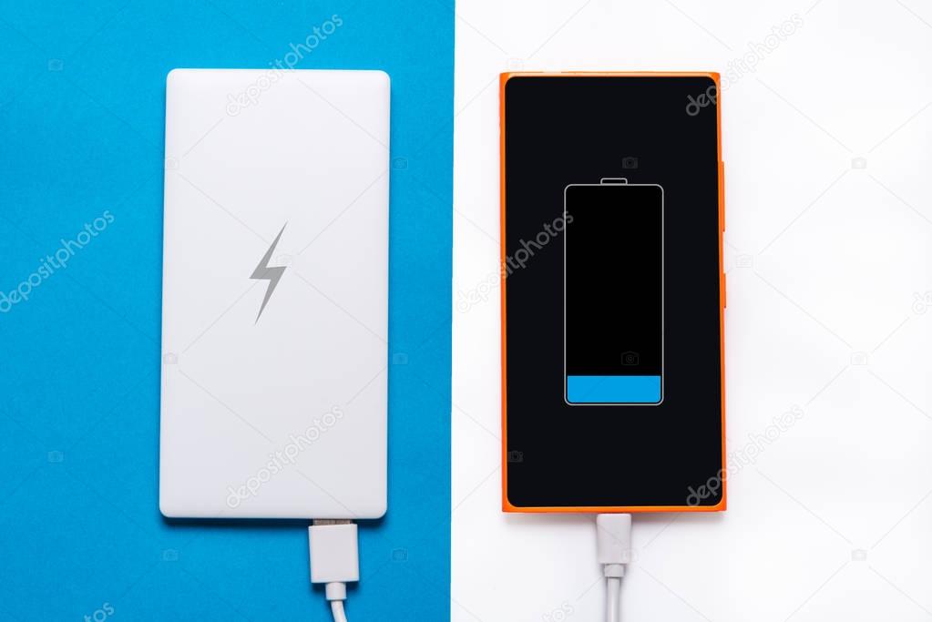 Power bank for smart phone on blue white background
