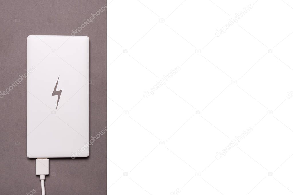 Power bank for smart phone on grey background
