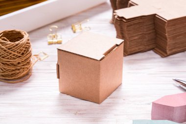Brown carton box on wooden table for favours