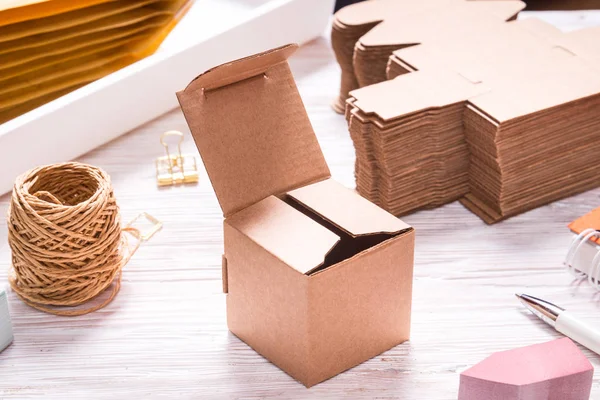 Brown carton box on wooden table for favours