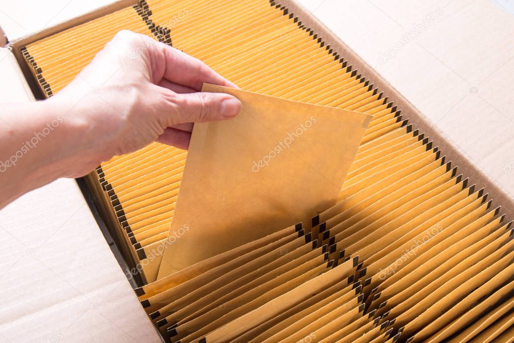 Lot of brown paper postal envelope in cardboard box