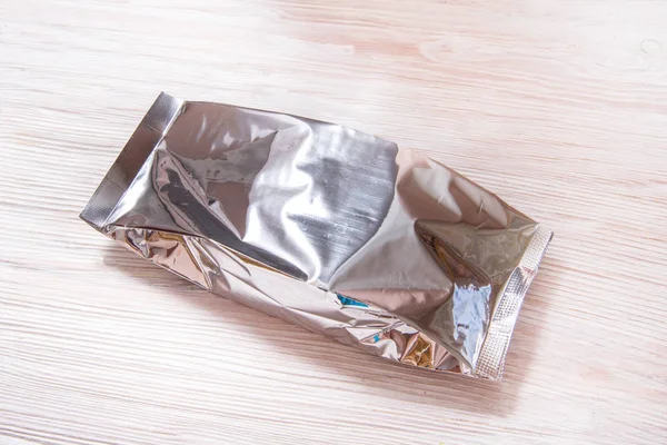 Foil package bag and white carton box on white wood background — 스톡 사진