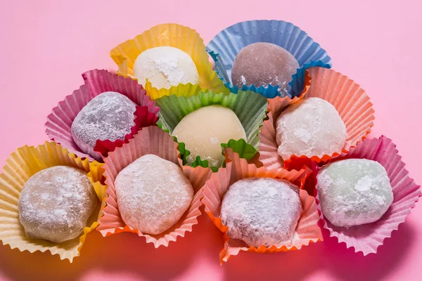 Πολλά mochi επιδόρπιο σε χάρτινα φλιτζάνια σε ροζ φόντο — Φωτογραφία Αρχείου