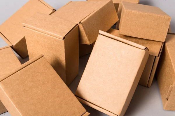 Set of brown cardboard mess boxes on grey background