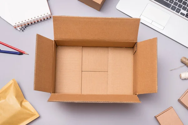Empty cardboard box on office desk, online stope packaging conce