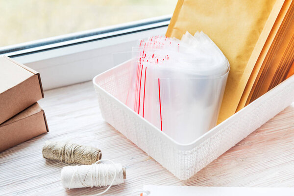 Lot of plastic zip locks on wooden office desk, small online bus