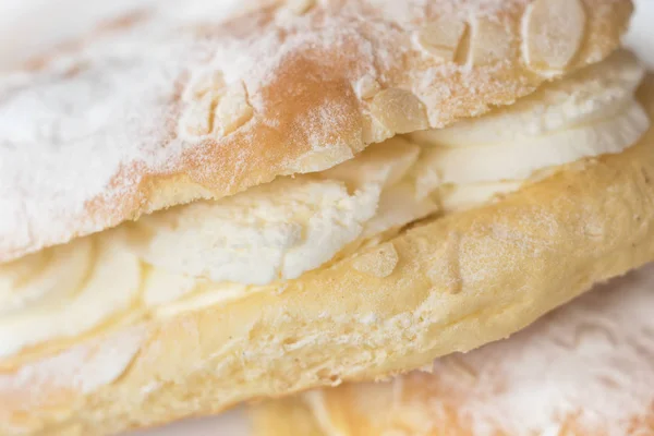 Delicious cream pastry macro picture, central selective focus. Stock Picture