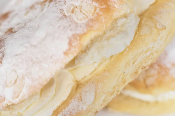 Delicious cream pastry macro picture, central selective focus. Stock Picture