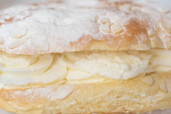 Delicious cream pastry macro picture, central selective focus. Stock Image