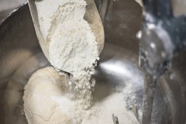 Loading flour into an industrial dough mixer. Close up view. — Stock Photo, Image