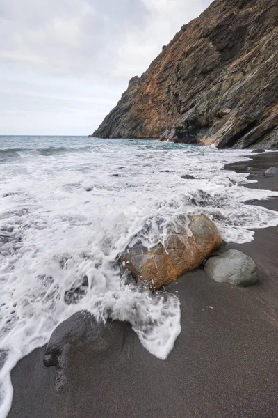 Wave spray splash over the rocky beach on a stormy day in La Gomera, Canary islands, Spain. — Stock Photo, Image