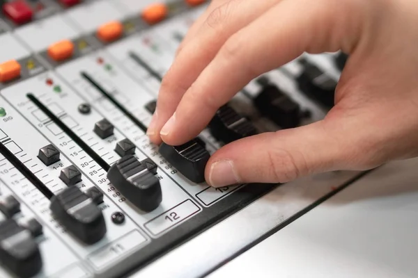 Male hand on control Fader on console. Sound recording studio mixing desk with engineer or music producer. — Stock Photo, Image