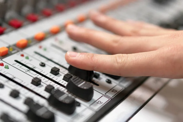 Male hand on control Fader on console. Sound recording studio mixing desk with engineer or music producer. — Stock Photo, Image