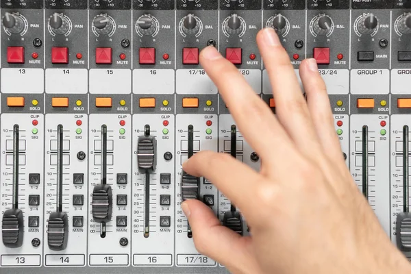 Close-up of a mixing console, hand equalizing audio channels. Professional recording studio. Working in recording studio. — Stock Photo, Image