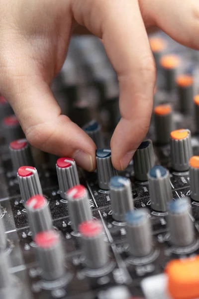 Close-up of a mixing console, hand equalizing audio channels. Professional recording studio. Working in recording studio. — Stock Photo, Image