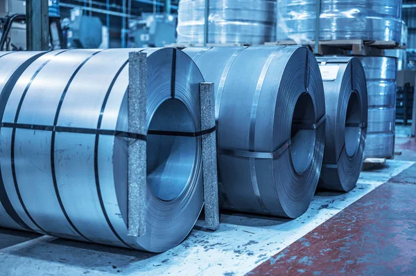 Fondo industrial. Bobina de acero de gran tamaño almacenada dentro del almacén industrial, imagen tonificada azul . — Foto de Stock