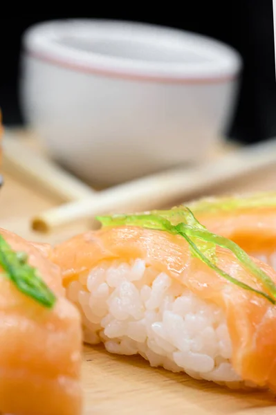 Japanese restaurant food. assorted sushi rolls on black isolated background.