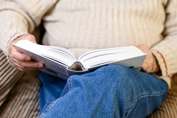 家で隔離されている間、本を読んでいる高齢者のビューを閉じます. — ストック写真