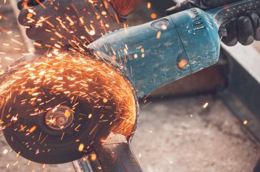 İnşaat işçisi inşaat alanında Öğütücü Kesici Metal kullanıyor..