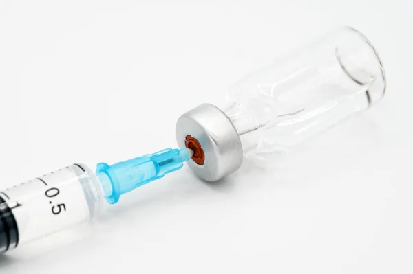 Medicine bottle for injection, medical glass vials and syringe for vaccination on white background.