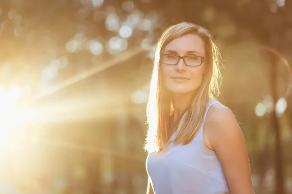 Портрет молодой женщины в очках в подсветке — стоковое фото