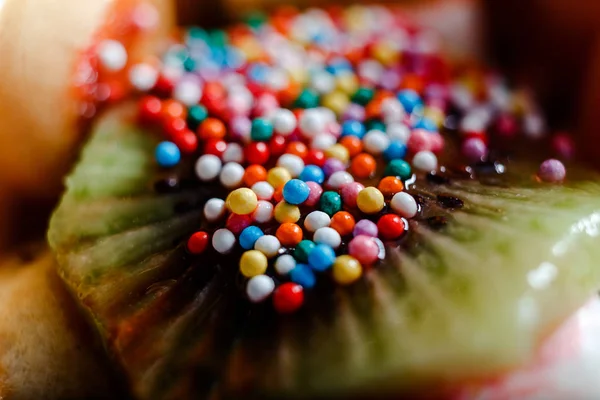 fruits decorated with confectionery sprinkles close up