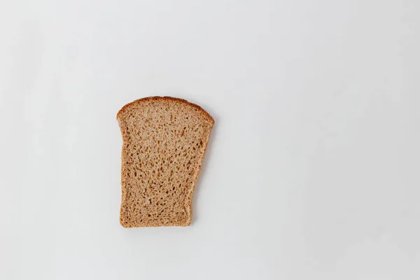 A slice of bread from the mixed flour on a white background — Stock Photo, Image