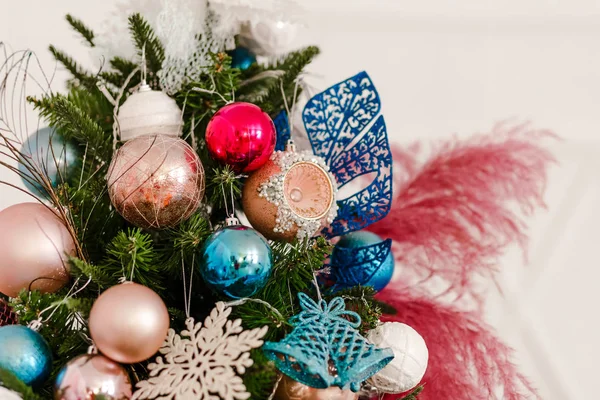 Stylish Christmas tree decorated with balls and feathers. — Stock Photo, Image