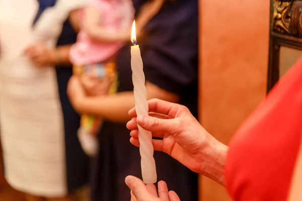 Burning candle in women's hands — Stock Photo, Image