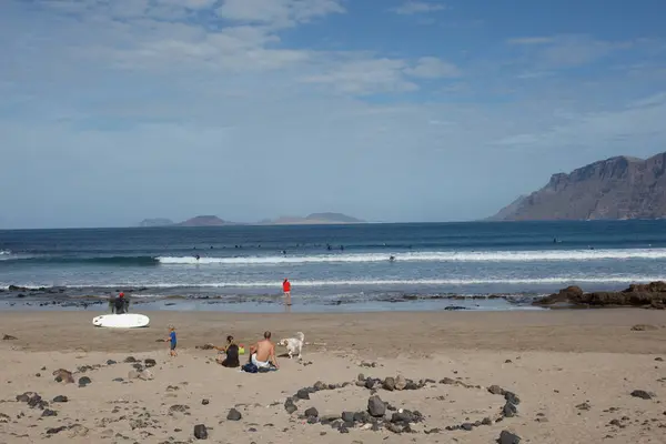 Surfistas y kiters en el mar en la playa de surf Famara —  Fotos de Stock