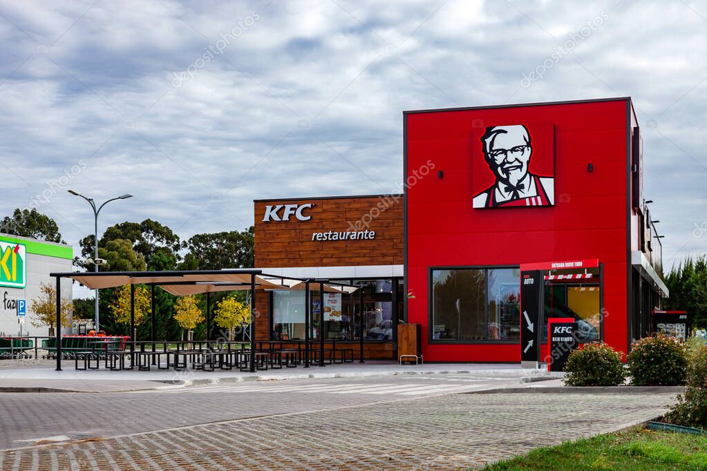 Coina, Portugal - October 23, 2019: KFC fast food restaurant with outdoor seating and Drive Thru. Kentuky Fried Chicken junk food in Barreiro Planet Retail Park