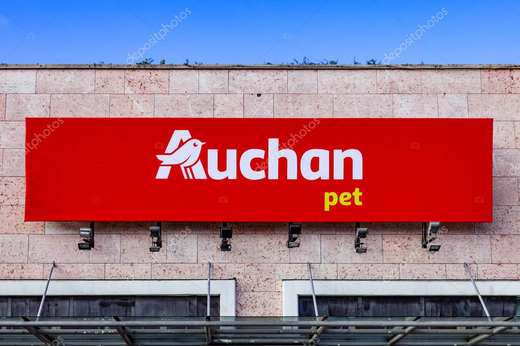 Almada, Portugal - October 24, 2019: Auchan Pet store or shop logo or symbol in the Almada Forum shopping mall or center. Auchan is a French hypermarket, supermarket or superstore chain