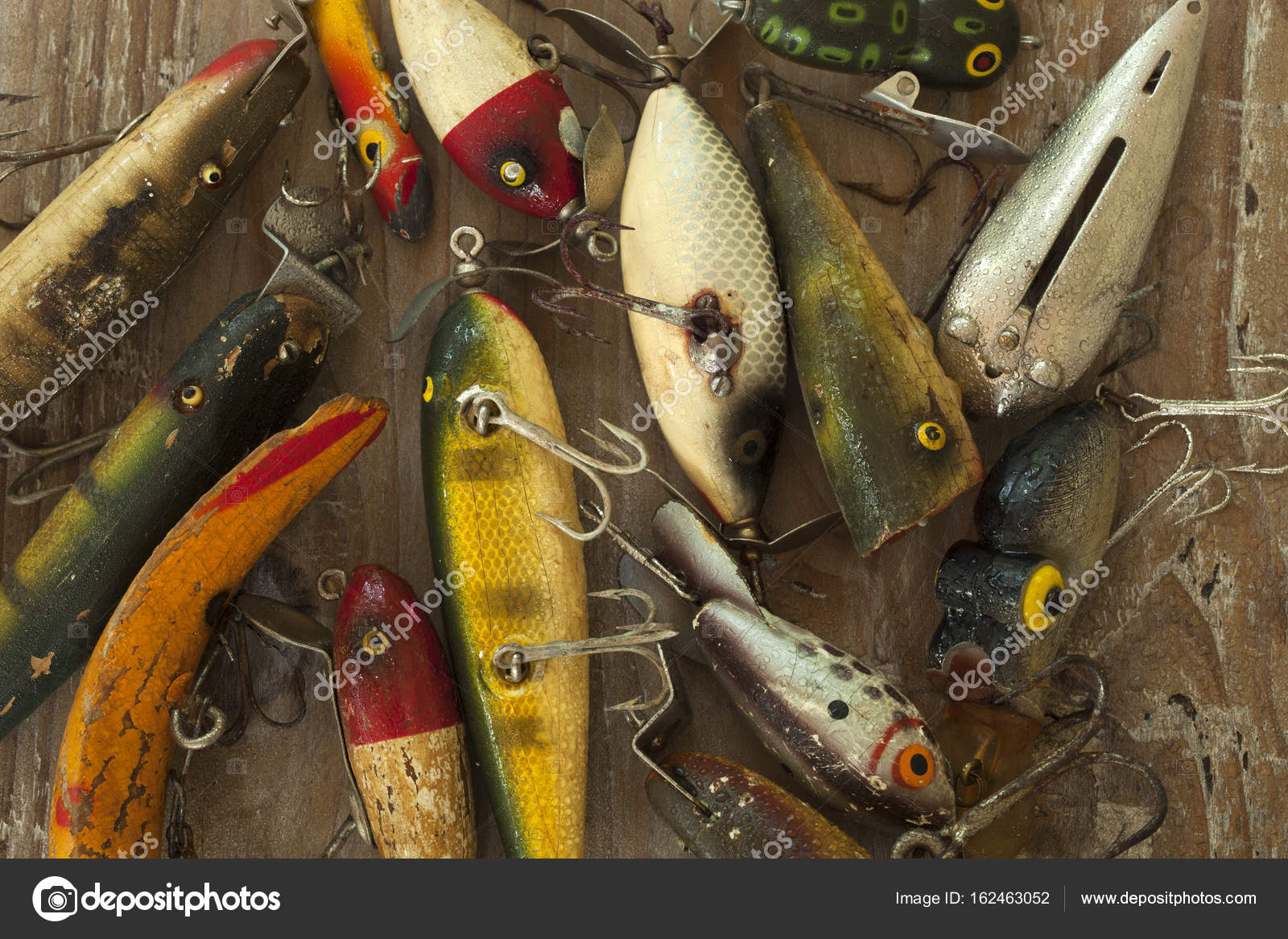 Wet antique fishing lures viewed from above on a rough wood surf Stock  Photo by ©Willard 162463052