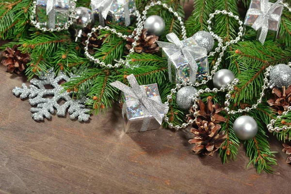 Silver Christmas decorations and spruce branch and cones — Stock Photo, Image