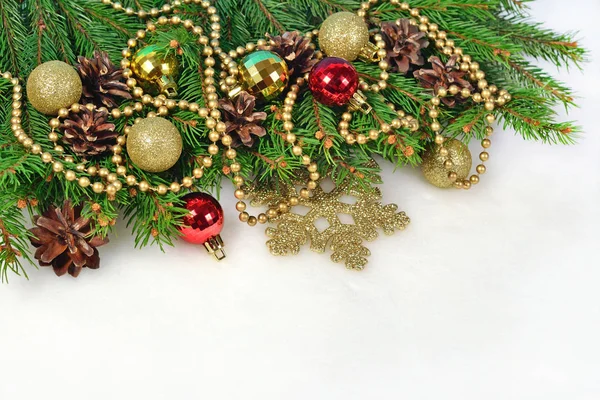 Christmas decorations and spruce branch and cones on a white — Stock Photo, Image
