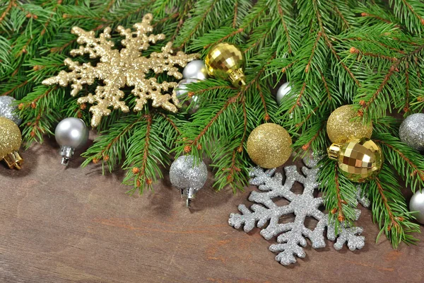 Golden and silver Christmas decorations and spruce branch — Stock Photo, Image