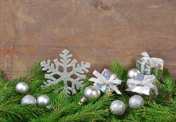 Silver Christmas decorations and spruce branch — Stock Photo, Image