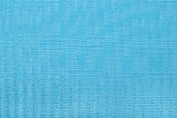 Blå plisserad transparent caprone tyg som bakgrund textur — Stockfoto