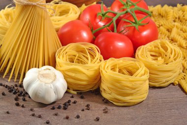 Pişmemiş makarna çeşitleri, olgun domates şube, sarımsak ve siyah p