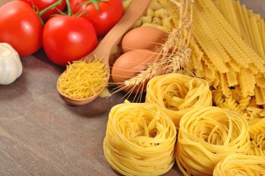 Pişmemiş makarna çeşitleri, olgun domates şube ve yumurta