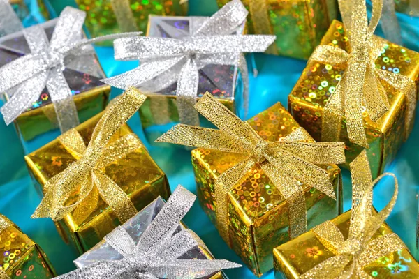 Top view of golden and silver gifts close-up on a blue — Stock Photo, Image