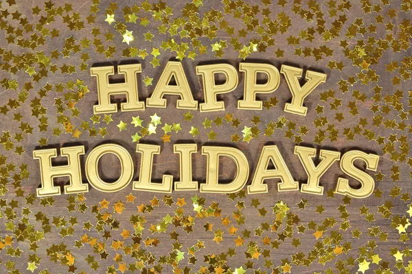 Happy holidays golden text and golden stars — Stock Photo, Image