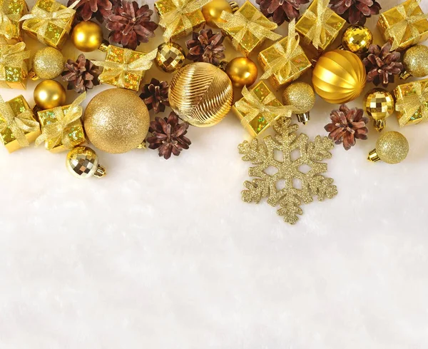 Golden Christmas decorations on a white — Stock Photo, Image